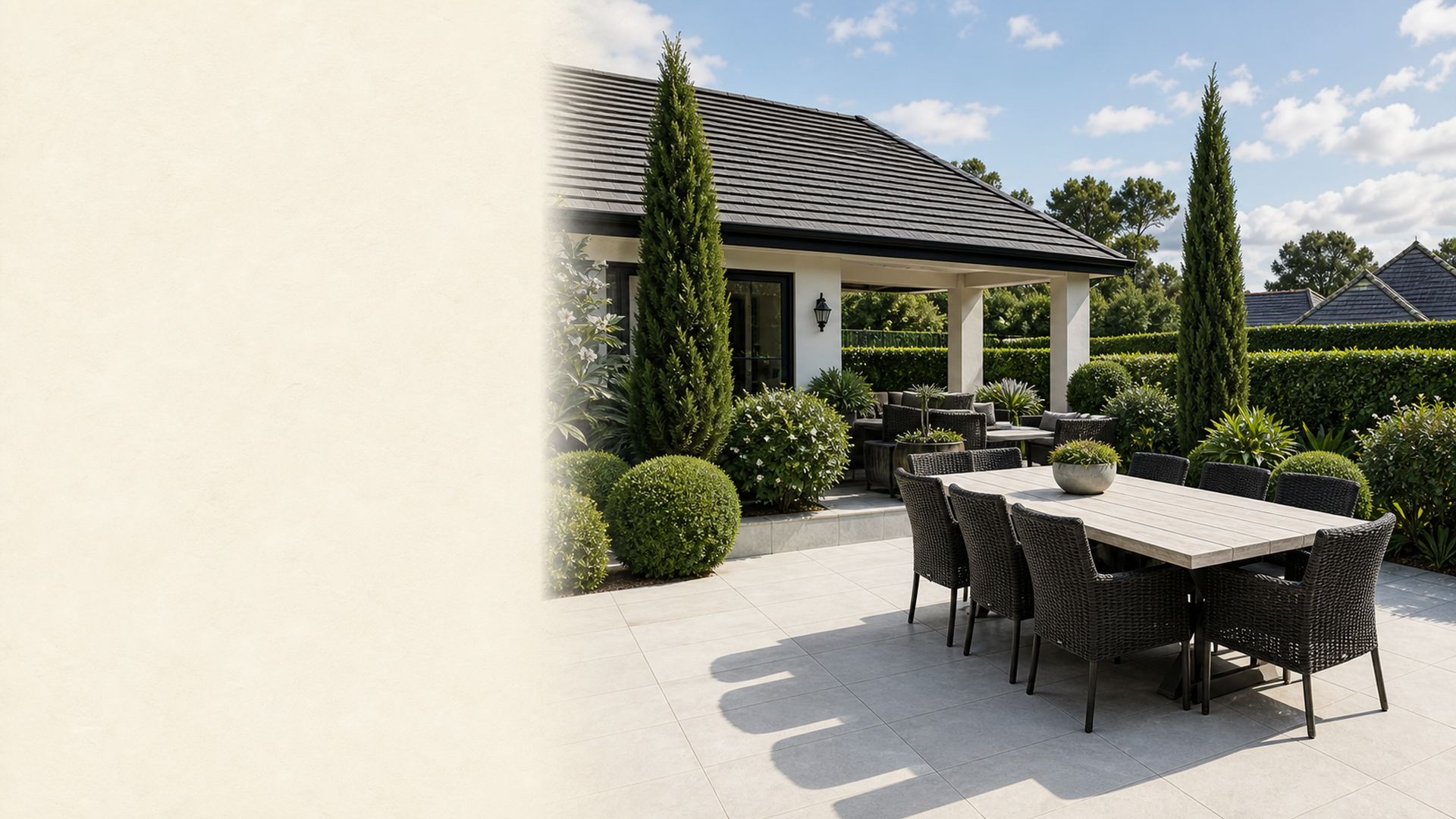 A finished outdoor dining terrace framed by structural planting